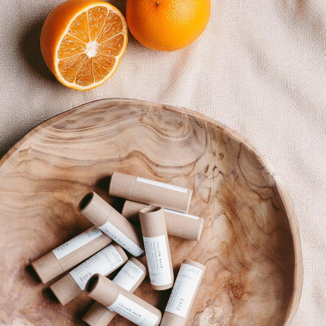 Lip balm in bowl with oranges