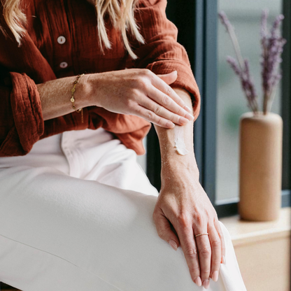 Person wearing a brown shirt applying tallow to their arm