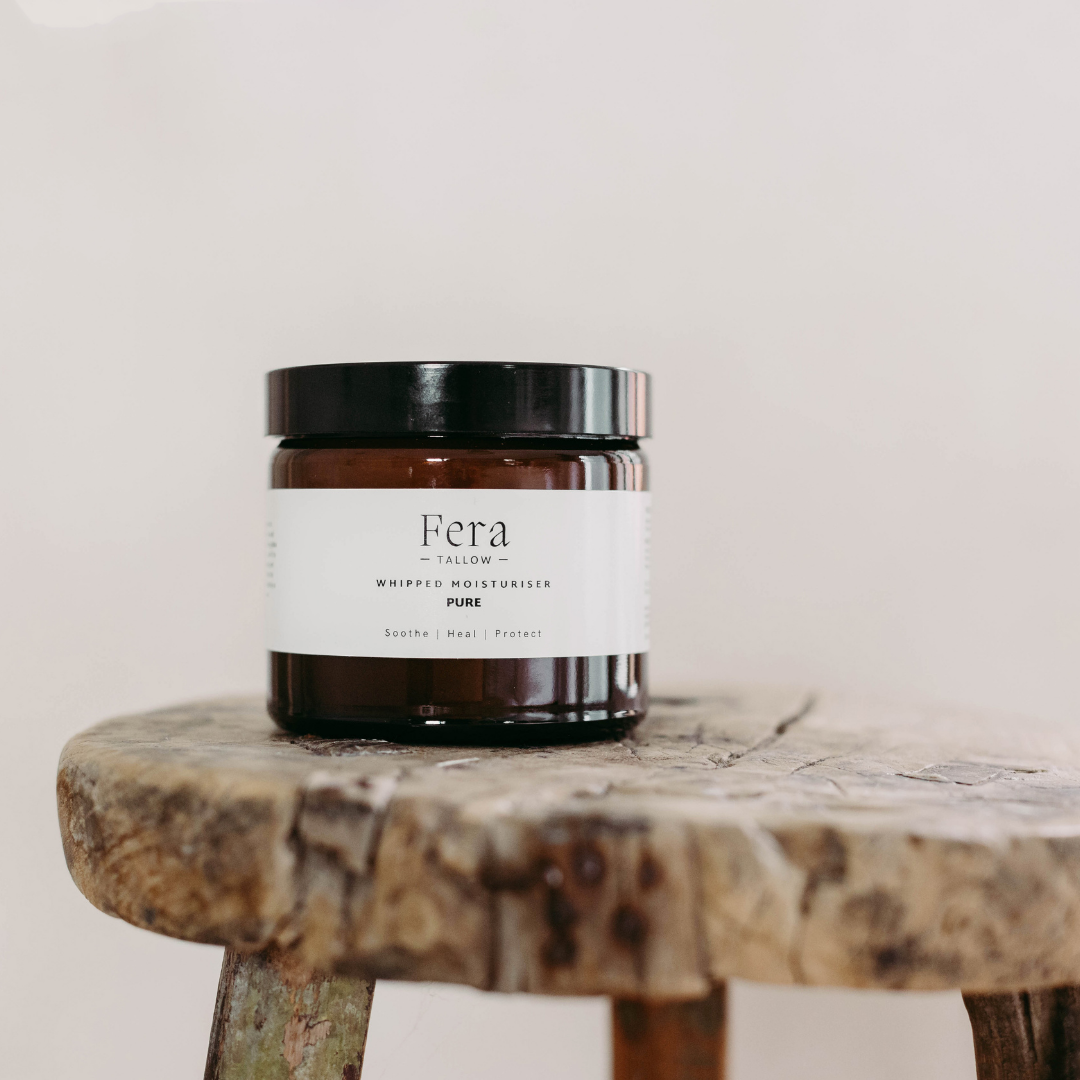 Large Jar of Fera Tallow whipped moisturiser on a wooden stool with a plain background